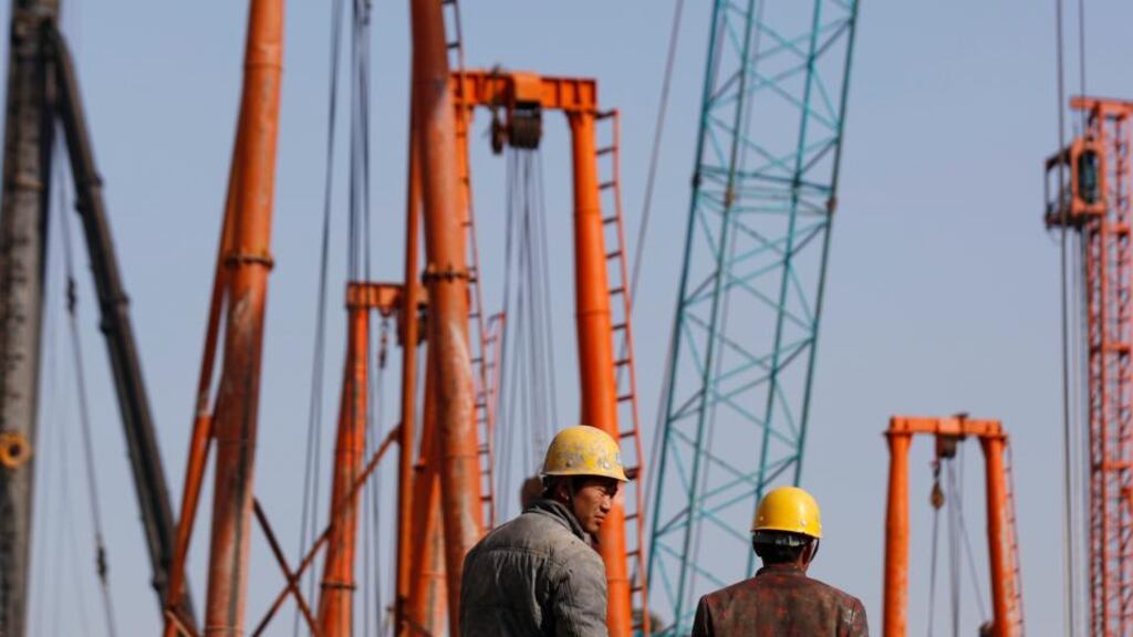 Labourers work at a construction site in Shanghai. Activity in China’s factory sector shrank in December for the first time in seven months as new orders declined, adding to expectations that more stimulus may be needed to avert a sharper economic slowdown. (Photograph: Aly Song/Reuters)