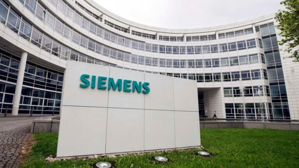 A Siemens logo is pictured at an office building of Siemens in Munich. Siemens plans to cut about 7,800 jobs, about 2 percent of its global workforce. Photo: Reuters