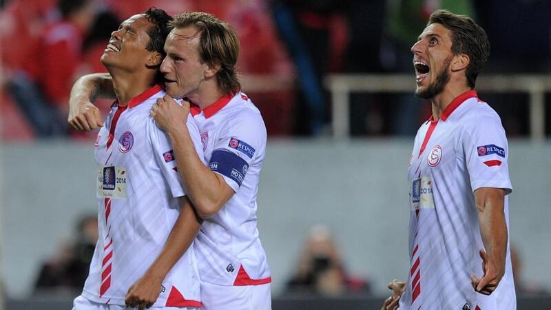 Carlos Bacca (left) of Sevilla celebrates with Ivan Rakitic and Daniel Carrico after scoring Sevilla’s second against Valencia CF at Estadio Ramon Sanchez Pizjuan. Photograph: Denis Doyle/Getty Images