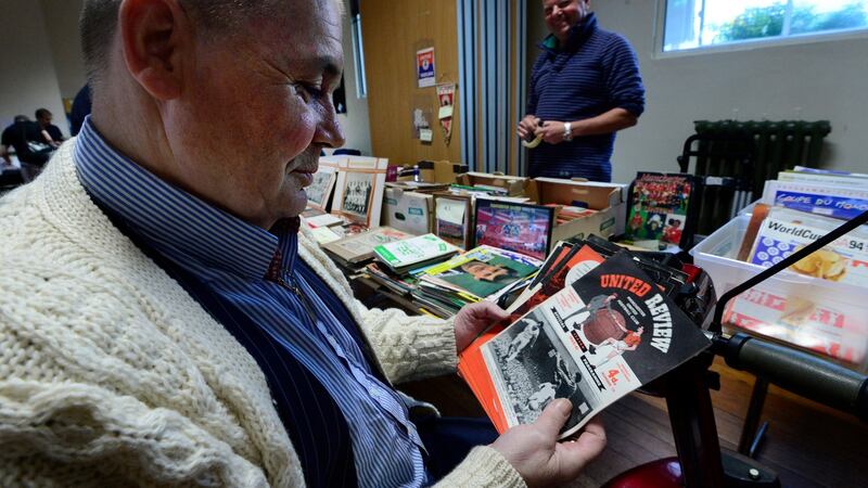 Richard Salenger looks through some Manchester United programmes from the 1950s. Photograph: Cyril Byrne