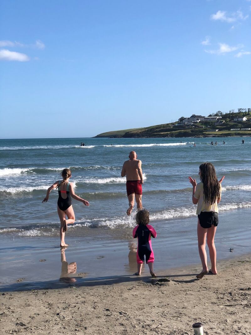 Conor Pope and his three daughters hit the waves at Inchydoney Beach in Cork. Photograph: Sonia Harris Pope