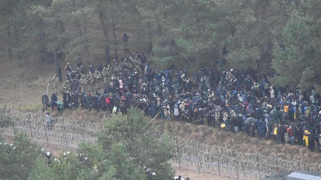 Migrants behind the border fence in Belarus near the Polish-Belarusian border crossing in Kuznica, eastern Poland. Photograph: EPA