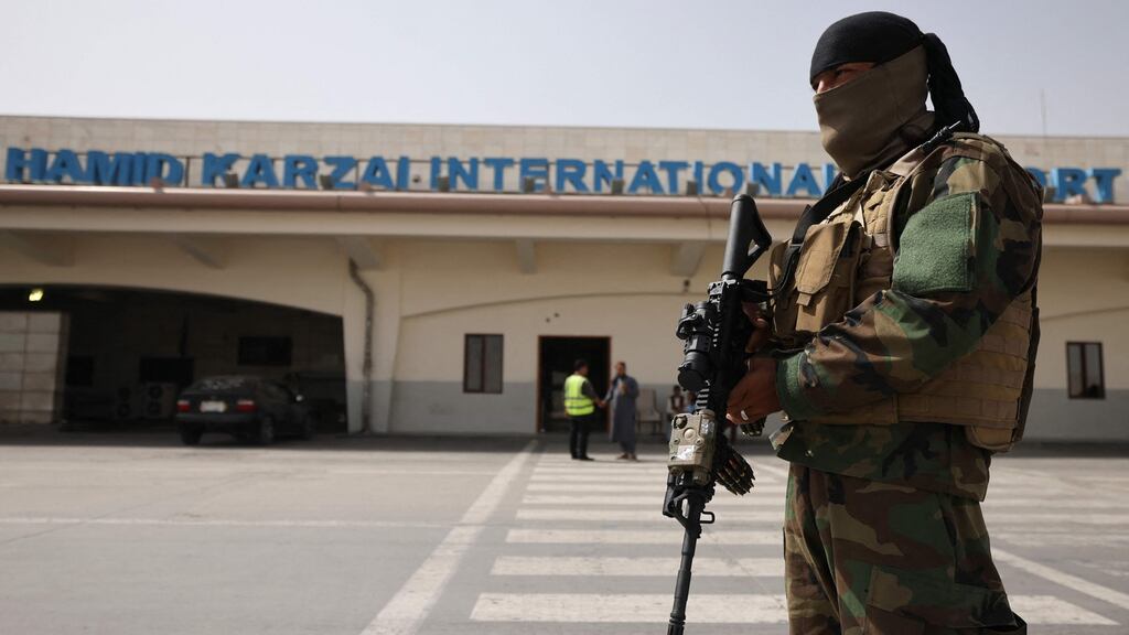 A Taliban fighter stands guard on the tarmac at the airport in Kabul where suicide bombers  killed 13 American troops helping with evacuations in August. Photograph: Karim Sahib/AFP via Getty