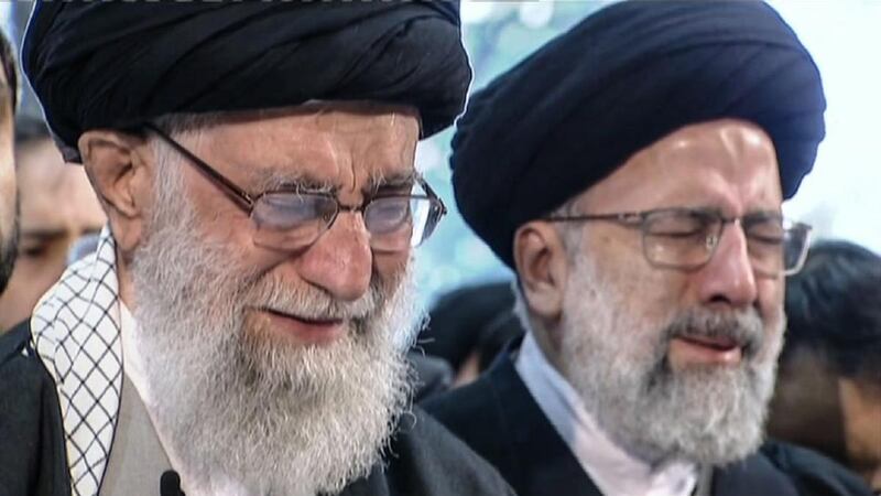 Iranian supreme leader Ayatollah Ali Khamenei (left) weeps as he recites a prayer in front of the coffin of Qassem Suleimani. Photograph: Iran Press/AFP via Getty Images