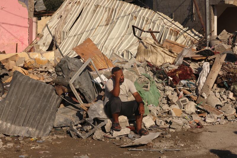 A Palestinian man sits on the debris of collapsed structures destroyed in the Israeli bombardment of Rafah in the southern Gaza Strip on Friday, Photograph: Getty images