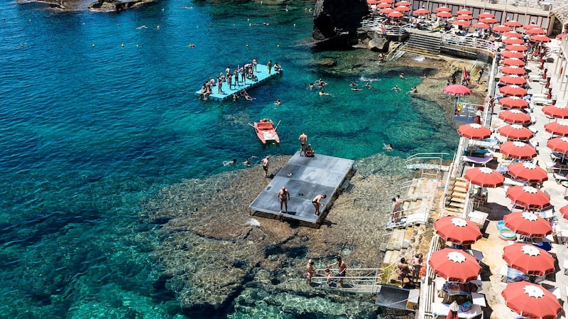 Santa Cesarea, Italy: People sunbathing and swimming in a resort in Santa Cesaria Terme, Lecce, Italy. Photograph: iStock