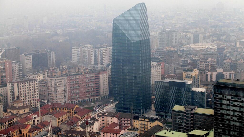 An aerial view of a skyscraper surrounded by smog in Milan, Italy where private are being banned for parts of three days in an attempt to bring down pollution levels that have been above the legal limit for some time. Photograph: Stefano Porta/EPA.