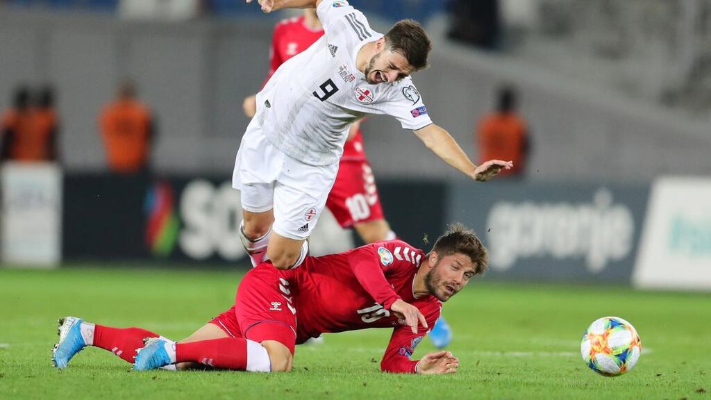 Denmark’s Lasse Schone in action against Georgia’s Otar Kiteishvili during the Euro 2020 Group D clash in Tbilisi. Photo: Zurab Kurtsikidze/EPA