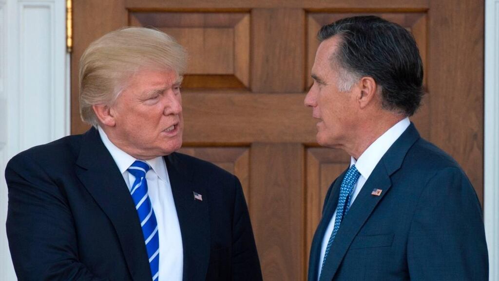 In this file photo taken on November 19th, 2016, Donald Trump shakes hands with Mitt Romney after their meeting at the clubhouse of Trump National Golf Club in Bedminster, New Jersey. Photograph: Don Emmert/AFP/Getty Images
