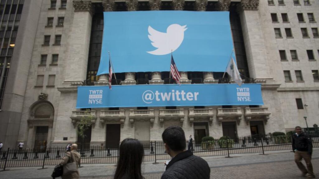 An @twitter banner is displayed on the exterior of the New York Stock Exchange. The microblogging company said revenue more than doubled to $312.2 million in the second quarter. Photo: Bloomberg