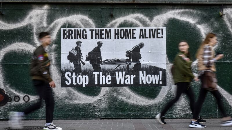 People pass an anti-war poster on Khreshatyk Street in Kyiv, Ukraine. Photograph: Oleg Petrasyuk/EPA