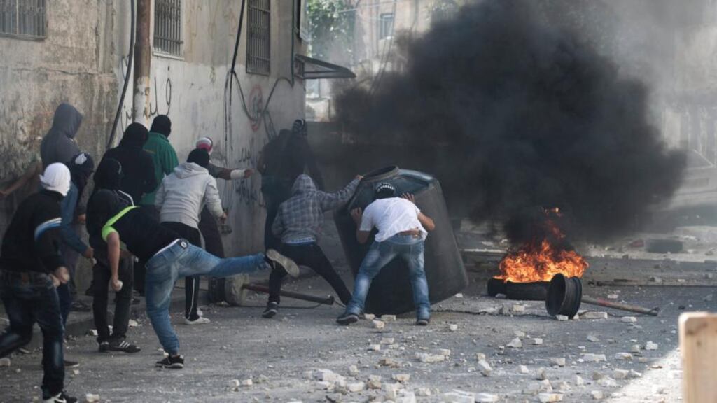 Palestinian stone throwers clash with the Israeli security forces in the East Jerusalem Arab neighborhood of Abu -tor, after Israeli police killed the Islamic Jihad activist Mu’ataz Hijazi, a suspect in the assassination attempt of the Israeli right-wing activist Rabbi Yehuda Glick. Photograph: Abir Sultan/EPA