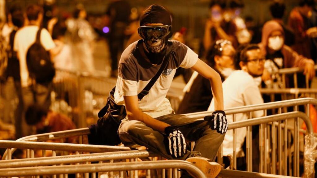 A pro-democracy protester from the Occupy Central movement retreats to a barricade area after police dispersed protesters along a tunnel road in the Admiralty District of Hong Kong today. Photograph: EPA