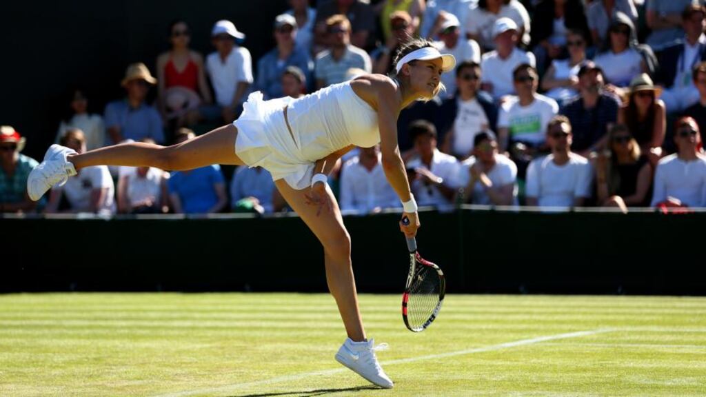 Eugenie Bouchard in action against Ying-Ying Duan at Wimbledon: the 21-year-old Canadian chose to play injured and lost 7-6(3), 6-4 in the first round. Photograph: Clive Brunskill/Getty Images