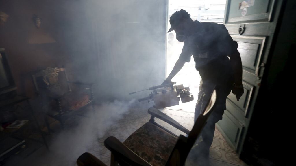 A Cuban military reservist fumigates inside a home in Havana on Monday in a bid to stave off the Zika virus. Photograph: Enrique de la Osa/Reuters