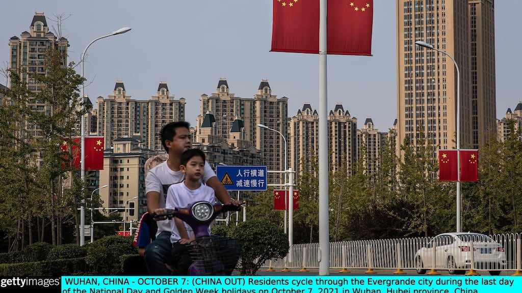 Residents cycle through the Evergrande city in Wuhan, China. Evergrande, China’s largest property developer, is facing a liquidity crisis with total debts of about $300 billion. Photograph: Getty