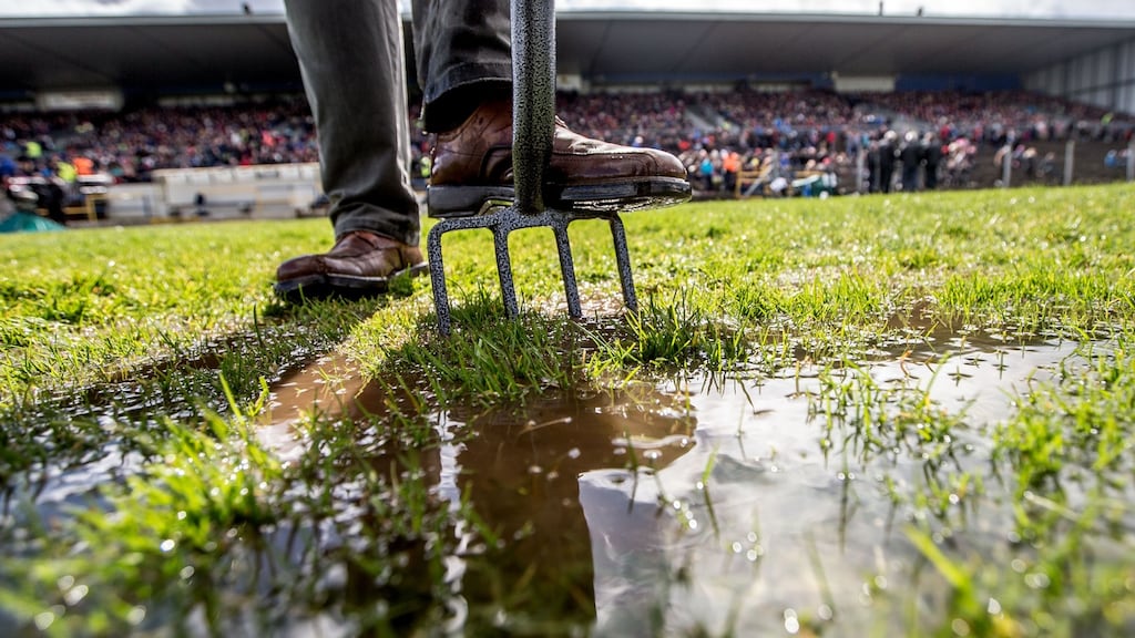A stewart tries to clear water before the Roscommon and Mayo game in Hyde Park last weekend. Photograph: James Crombie/Inpho