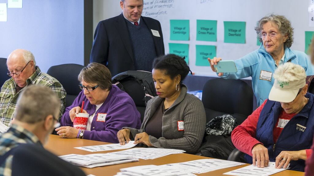 Designated observers watch as tabulators work on recounting presidential ballots in Dane County in Madison, Wisconsin. Photograph: Andy Manis/Getty Images