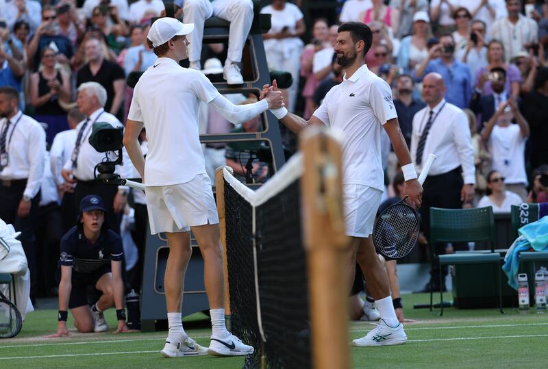 Jannik Sinner and Novak Djokovic shake hands after their semi-final on Friday. Photograph: Clive Brunskill/Getty Images