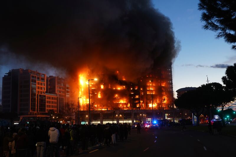 People watch the fire in Valencia from a distance. Photograph: Alberto Saiz/AP