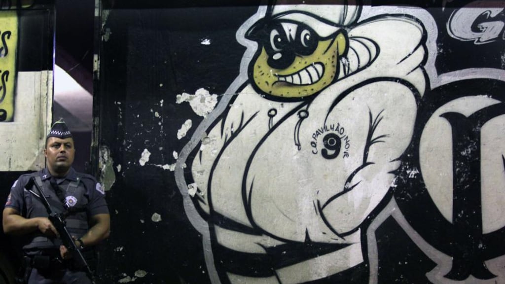 A policeman outside the Corinthians fans’ headquarters in Vila dos Remedios, near São Paulo, after a shooting that left eight people dead on Saturday night. Photograph: Fernando Neves/AFP/Getty Images