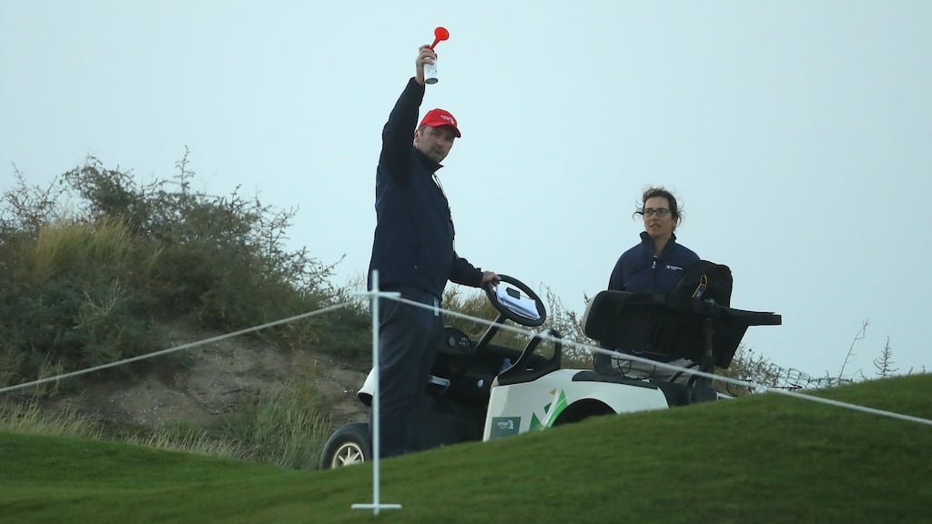 European Tour referee Kevin Feeney sounds the hooter to suspend play on day three in Oman. Photograph: Warren Little/Getty