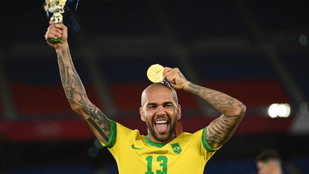 Brazil captain Dani Alves celebrates after receiving his gold medal on the podium after the win over Spain in the Olympic Games men’s soccer final at Yokohama International Stadium. Photograph: Anne-Christine Poujoulat/AFP via Getty Images