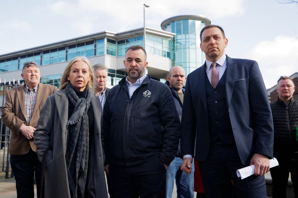 Linda McErlean, partner of Gary Convie, Kieran Fox, son of Eamon Fox, with legal representative Padraig O Muirigh outside Belfast Crown Court after James Smyth was found not guilty of the murders of the Catholic workmen Eamon Fox and Gary Convie in 1994. Photograph: Liam McBurney/PA Wire
