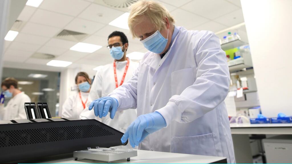 British prime minister Boris Johnson (right) is shown the latest technology by Ahmed Elkaskis, a PHD student at Wellcome-Wolfson Institute For Experimental Medicine, Queen’s University Belfast on Friday. Photograph: Peter Morrison/WPA Pool/Getty Images.