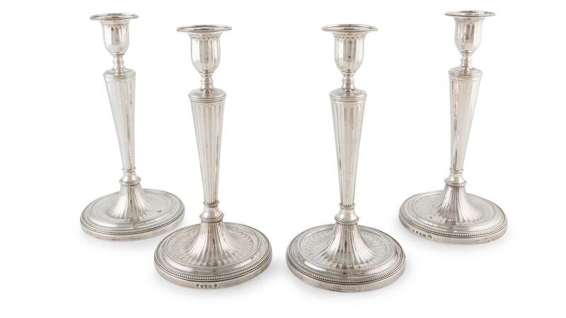 Four silver candlesticks.
