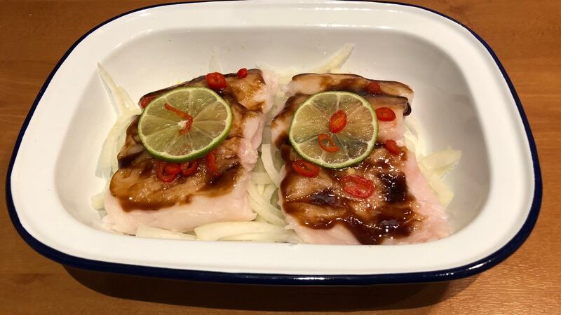 Smear oyster sauce all over the fillet with the back of a spoon and sprinkle the chopped chilli, lime slices and a little white pepper over the fillet.