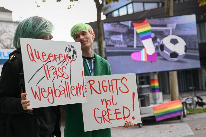 Activists hold boards reading in German 'shooting at queer hate' during a symbolic action by LGBT+ associations in front of the Fifa museum in Zurich on November 8, 2022. Photograph: Fabrice Coffrini/Getty Images