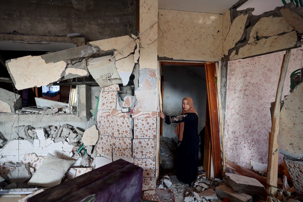 A woman stands in her destroyed house in Rafah, on the southern Gaza Strip. Photograph: AFP via Getty Images