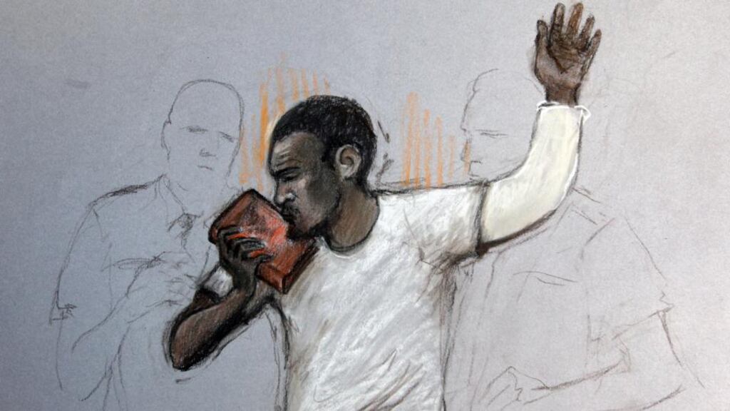 A court sketch of Michael Adebolajo kissing the Koran during his appearance at Westminster Magistrates’ Court in London today. Photograph: Elizabeth Cook/PA Wire