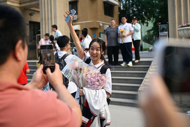 A student is presented with flowers at the end of the gaokao in Beijing. Photograph: Wang Zhao AFP via Getty