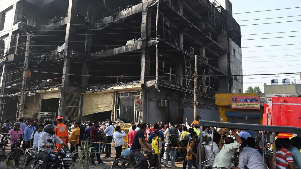 Some people jumped from windows to save themselves, according to eyewitnesses, and firefighters broke the glass and rescued people with ropes. Photograph: SAJJAD HUSSAIN/AFP via Getty Images