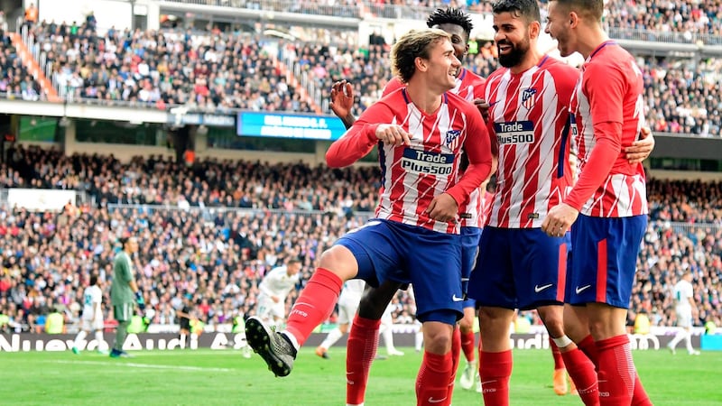Atletico Madrid’s Antoine Griezmann celebrates a goal with team-mates during the La Liga game against Real Madrid at the Santiago Bernabeu stadium. Photograph: Javier Soriano/AFP/Getty Images