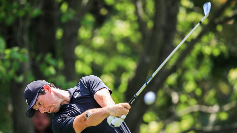 Rory hits his tee shot on the second hole before play was suspended. Photo: Tannen Maury/EPA