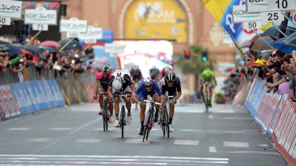 French rider Nacer Bouhanni (centre) of the FDJ.fr team sprints  his way to victory on the  fourth stage, 112 km from Giovinazzo to Bari, of the 97th Giro d’Italia. Photograph:  Luca Zennaro/EPA