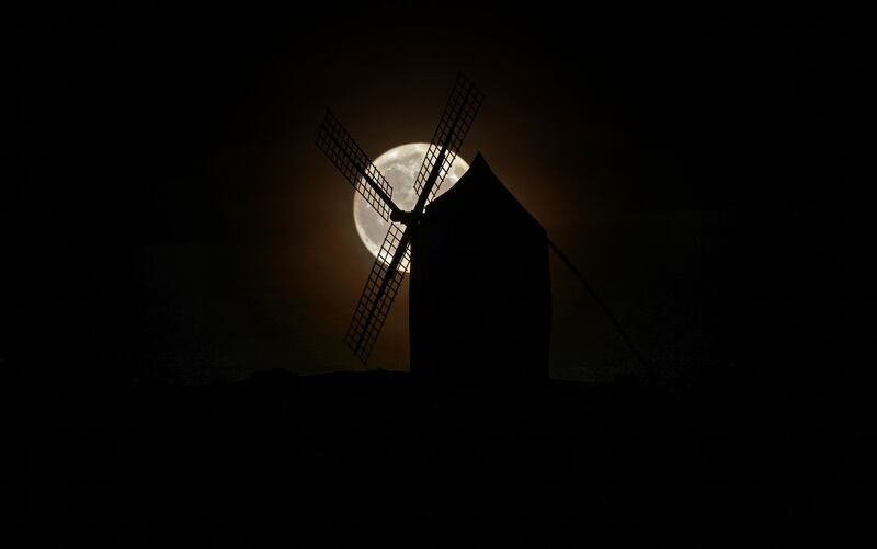 The super blue moon rises over a windmill in Consuegra, Ciudad Real province. Spain. Photograph: THOMAS COEX/AFP via Getty Images