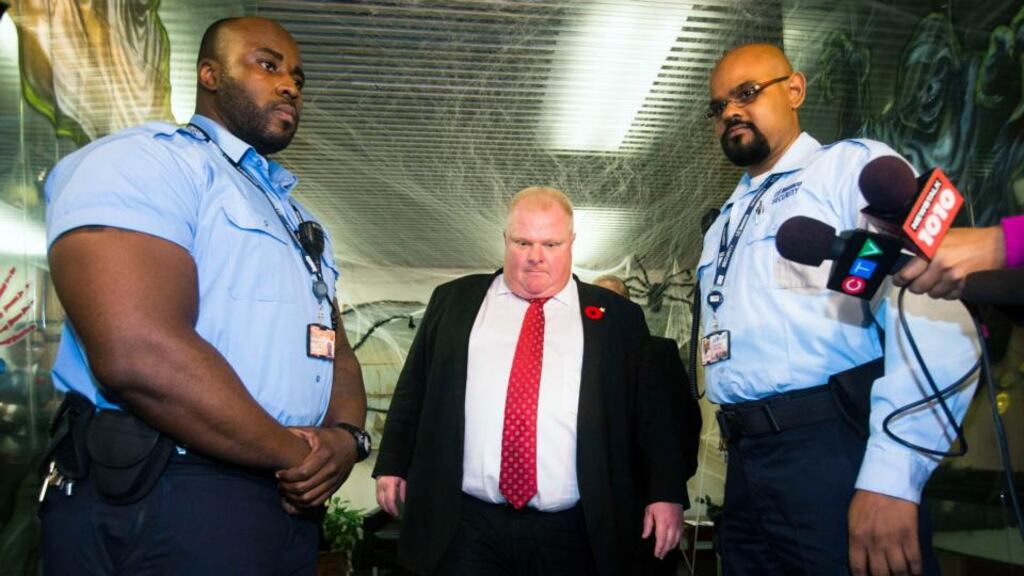 Toronto Mayor Rob Ford walks between two security guards before he responds to the Toronto police investigation dubbed “Project Brazen 2” to the media at City Hall in Toronto today. Photograph: Mark Blinch/Reuters.