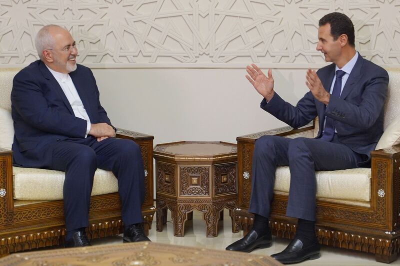 This picture released by the official Syrian Arab News Agency shows Iran’s Foreign Minister Mohammad Javad Zarif (left) meeting with Syrian President Bashar al-Assad in Damascus on Monday.  Photograph: AFP/Getty Images