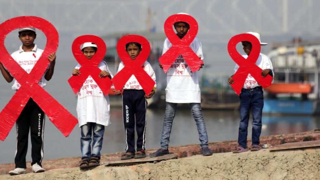 Positive children hold Red Ribbons on the eve of World Aids Day (December 1st) on the bank of river Ganges, Calcutta, India. Photograph: Piyal Adhikary/EPA