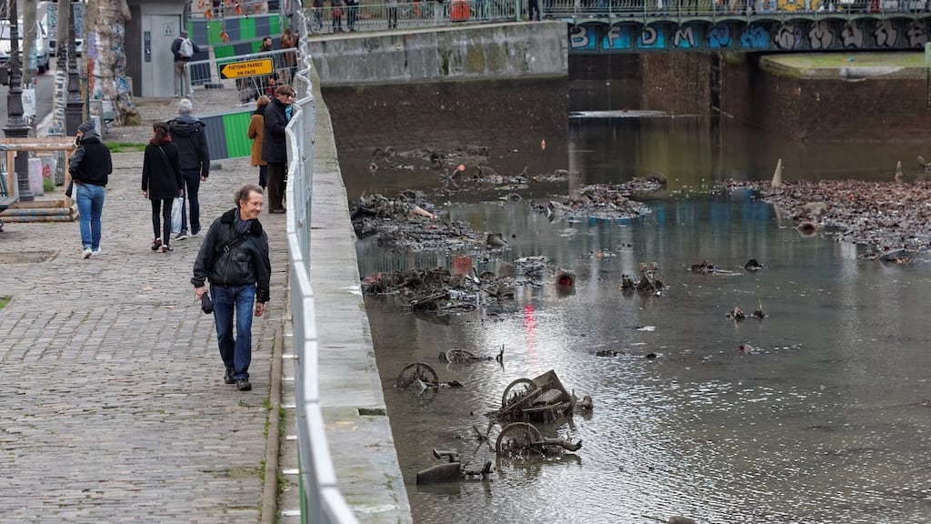 Parisians inspecting the drained Saint-Martin canal and the lamentable dumping of many items in the facility, including 100 electric bicycles. Photograph: Coyau Wikimedia Commons