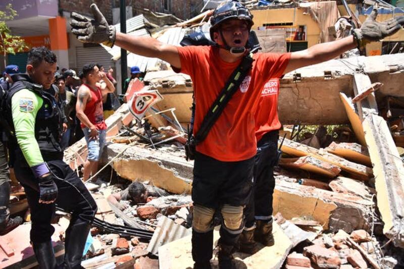 Emergency services work to free people from rubble. Photograph: AP