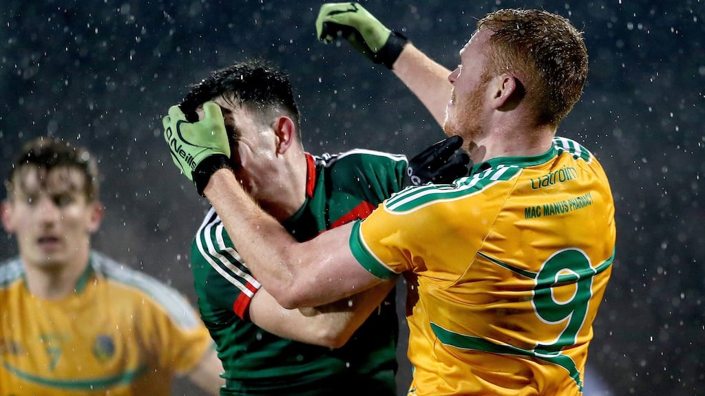 Mayo’s Ross Egan and Colm Moreton of Leitrim clash during their FBD Connacht League encounter. Photo: James Crombie/Inpho