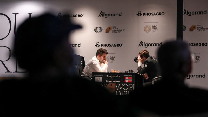 Defending Champion Magnus Carlsen (R)of Norway plays against Ian Nepomniachtchi (L) of Russia during the 9th round of FIDE World Chess Championship. Photograph: Ali Haider/EPA