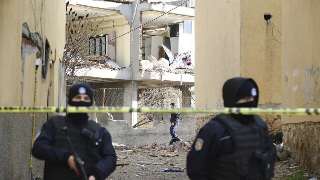 Turkish police stand guard near a building damaged by a truck bomb on a police station in Cinar, southeastern city of Diyarbakir, Turkey. Photograph: Reuters
