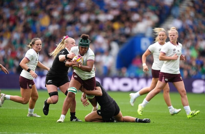 Ireland's Grace Moore (centre) powers past two New Zealand tackles during an impressive individual performance. Photograph: PA