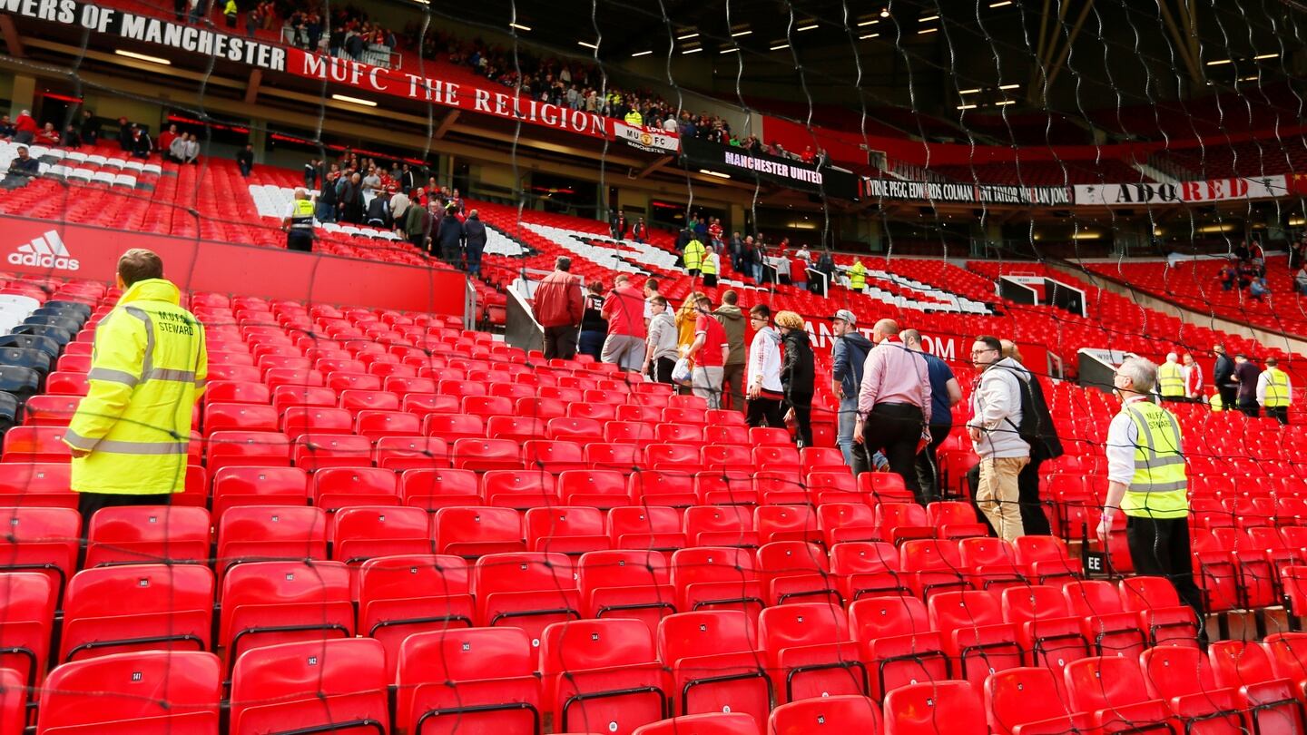 Fans are evacuated from the stadium before the match. Photo: Jason Cairnduff/Reuters